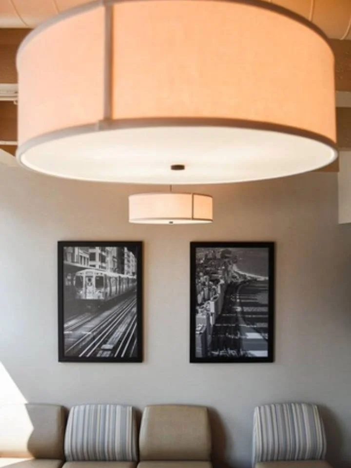 Interior of a room with two large hanging ceiling lights.
