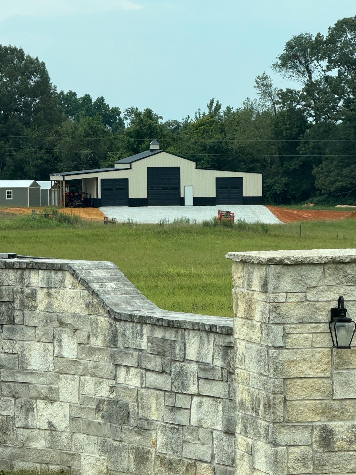 Custom 24x48x16 post-frame building with a 12x48x13 lean-to in Jackson, TN featuring Light Stone met