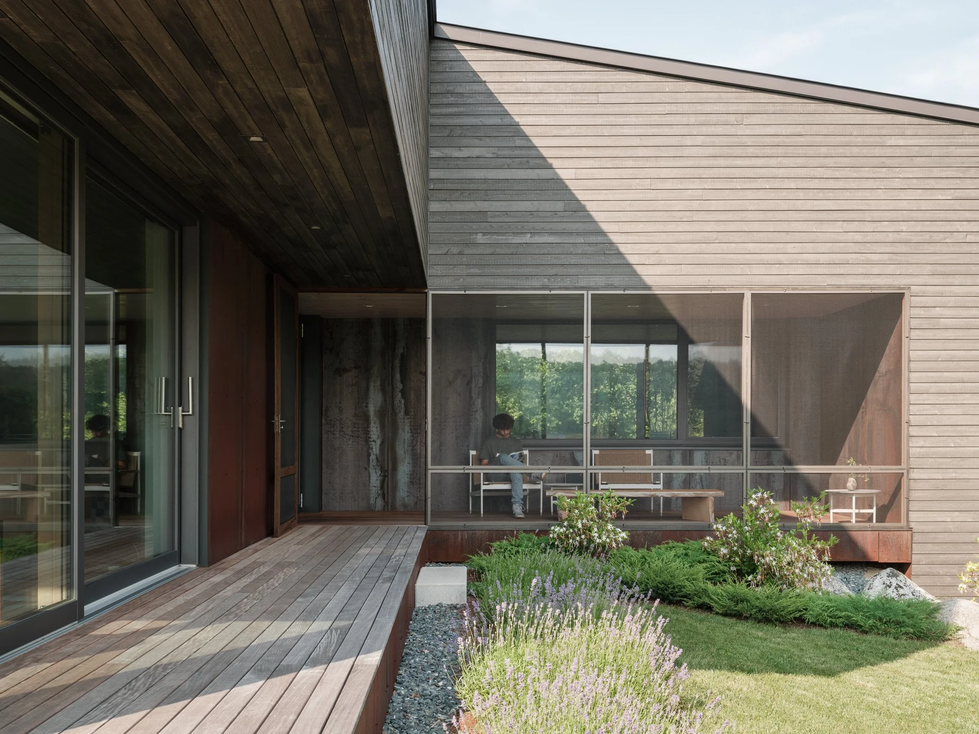House with stained eastern white cedar and Corten steel panels