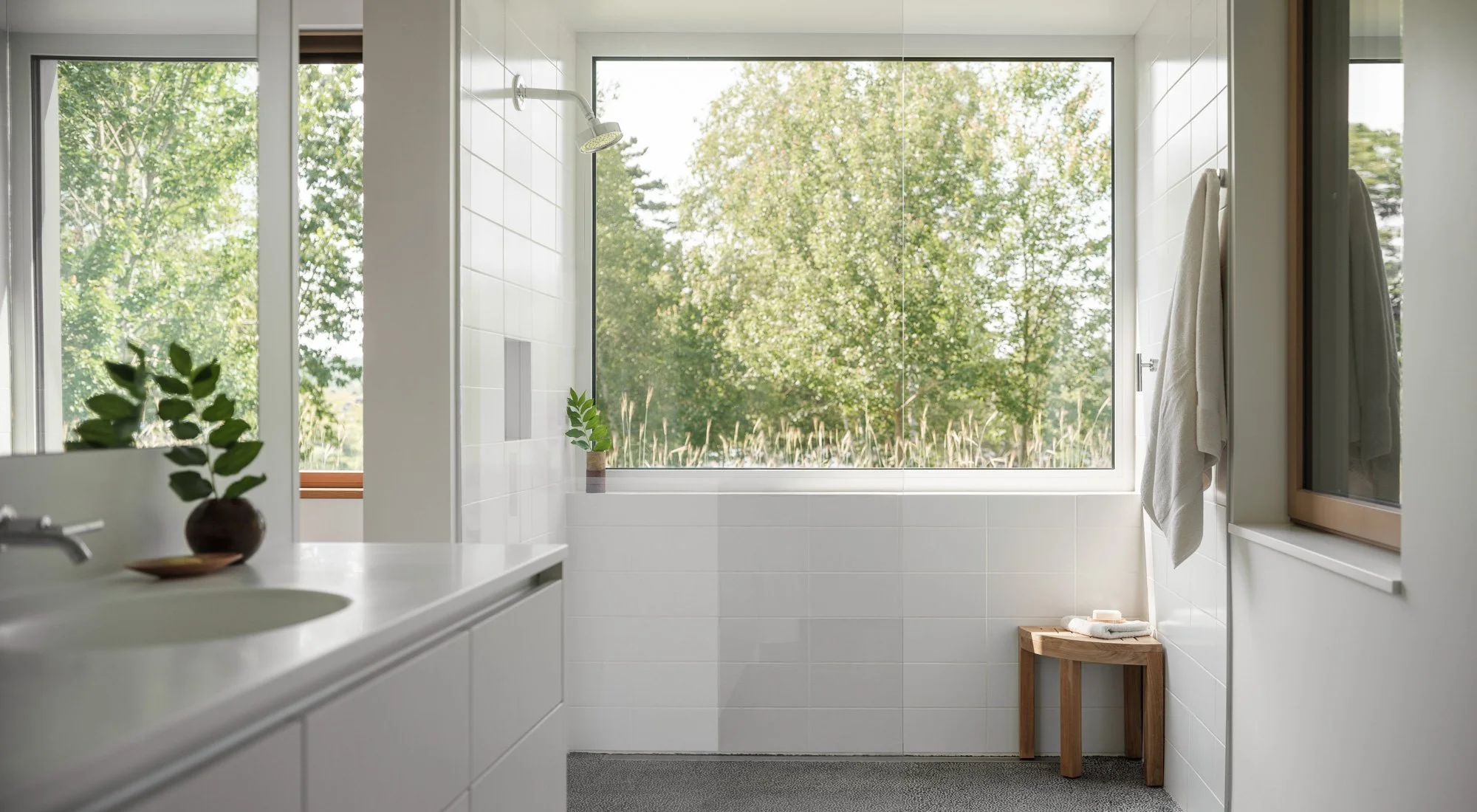 all white modern bathroom with tile by Mosa