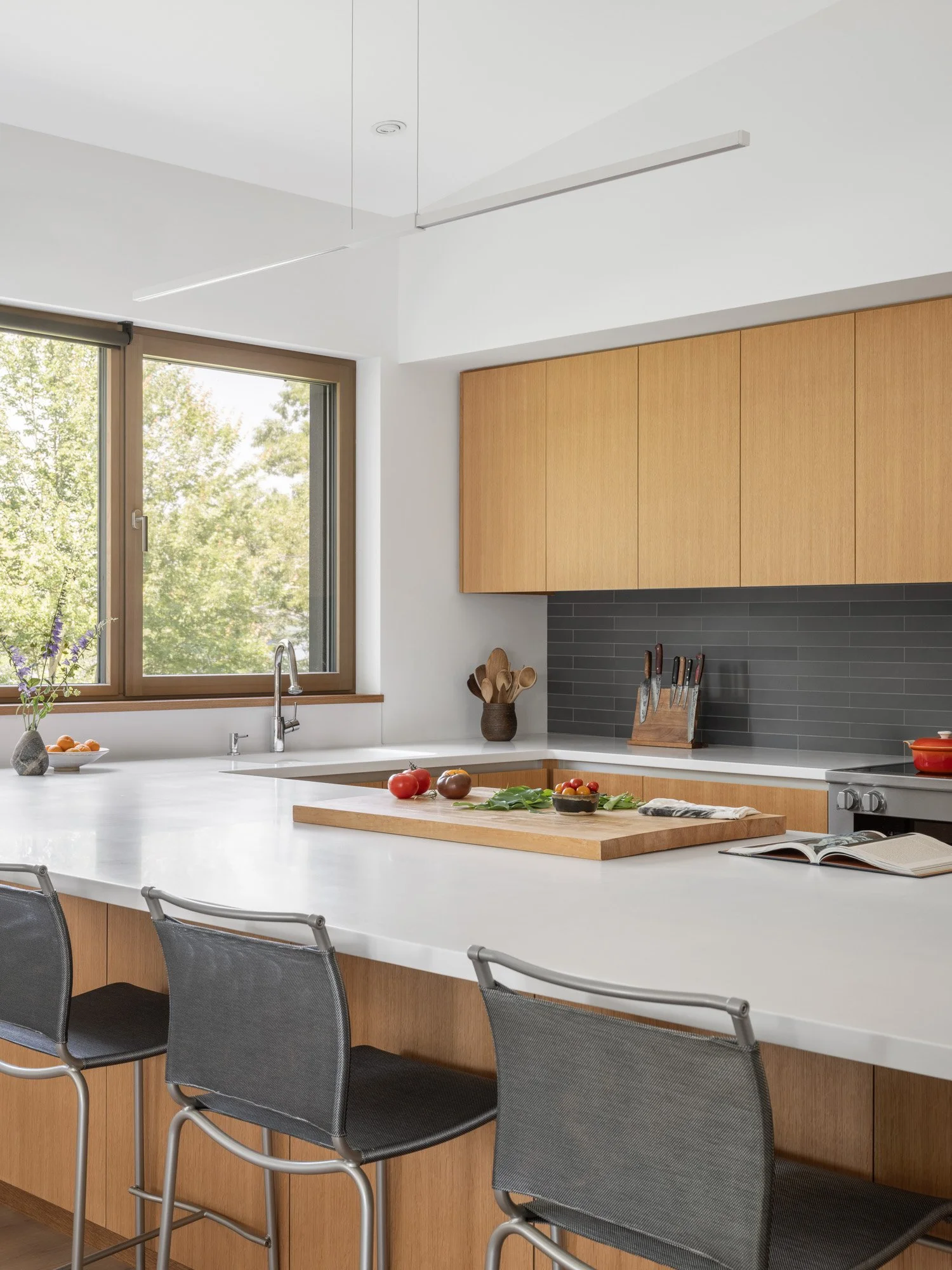 Kitchen with countertop by Corian in Glacier White and tile by Mutina