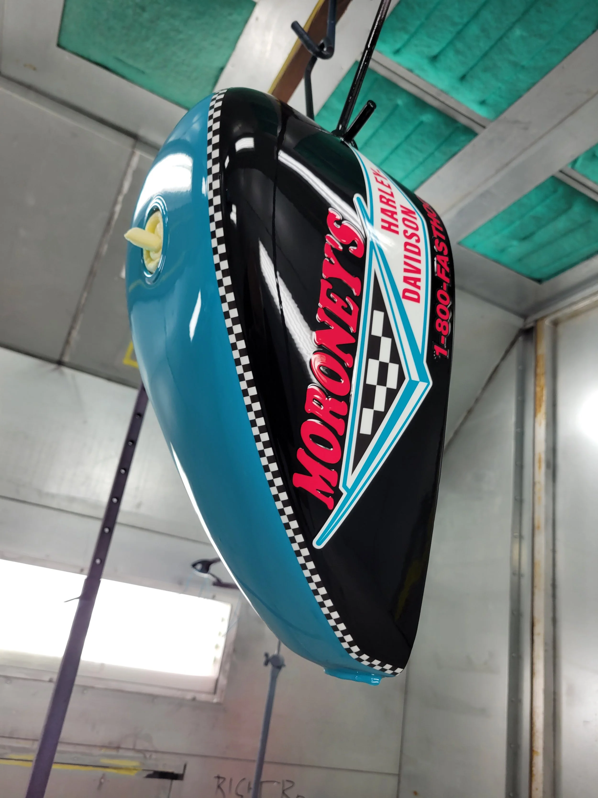 Racing fuel tank with graphics, featuring checkered patterns 