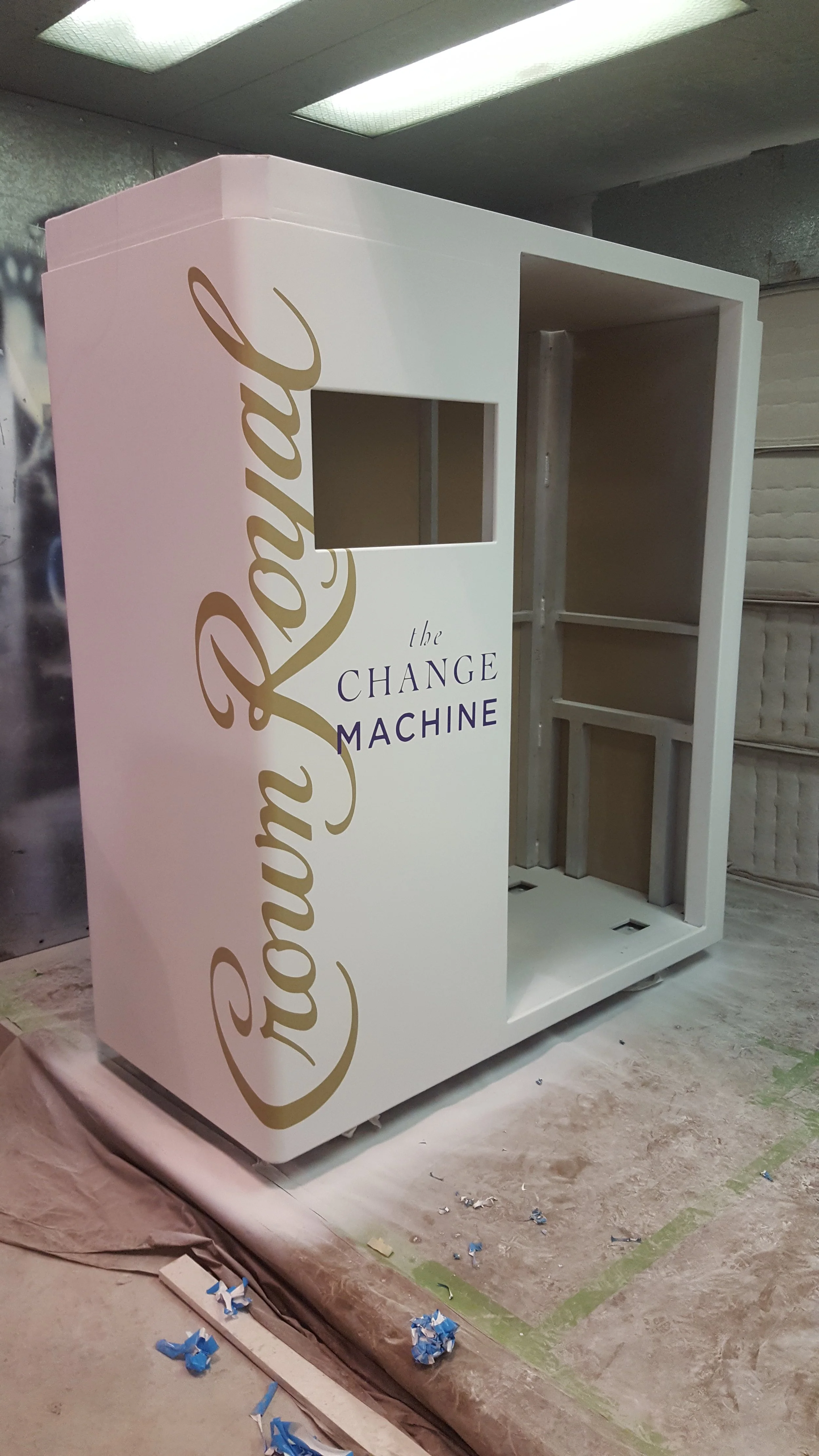 A white photo booth with the words 'the Change Machine' written on it. 