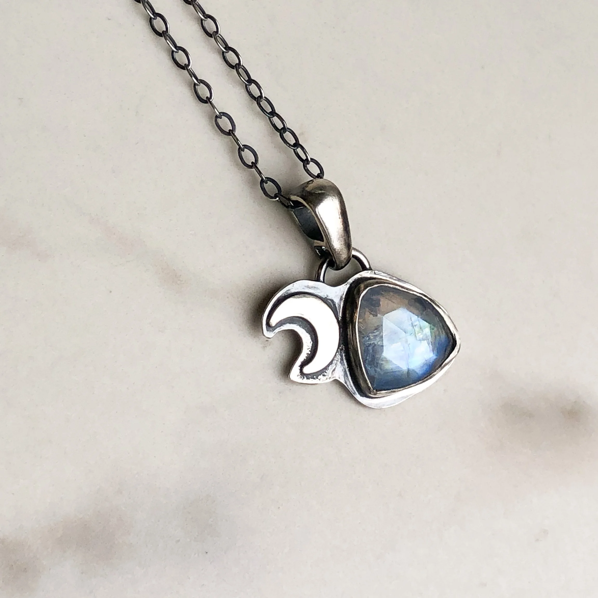 Moonstone triangle necklace with a silver crescent accent