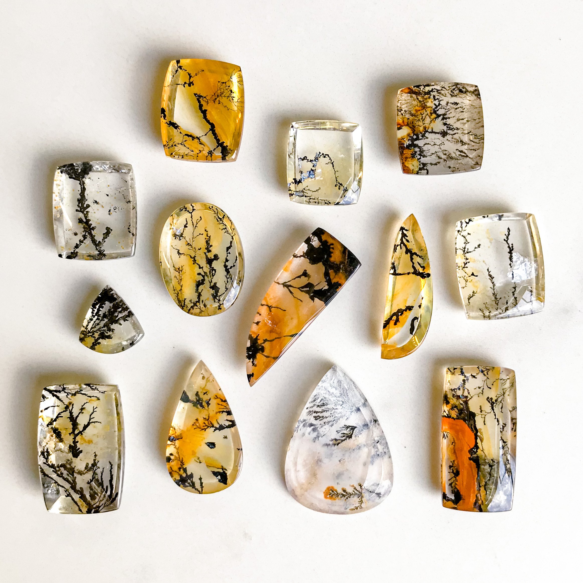 a loose collection of dendritic quartz cabochons