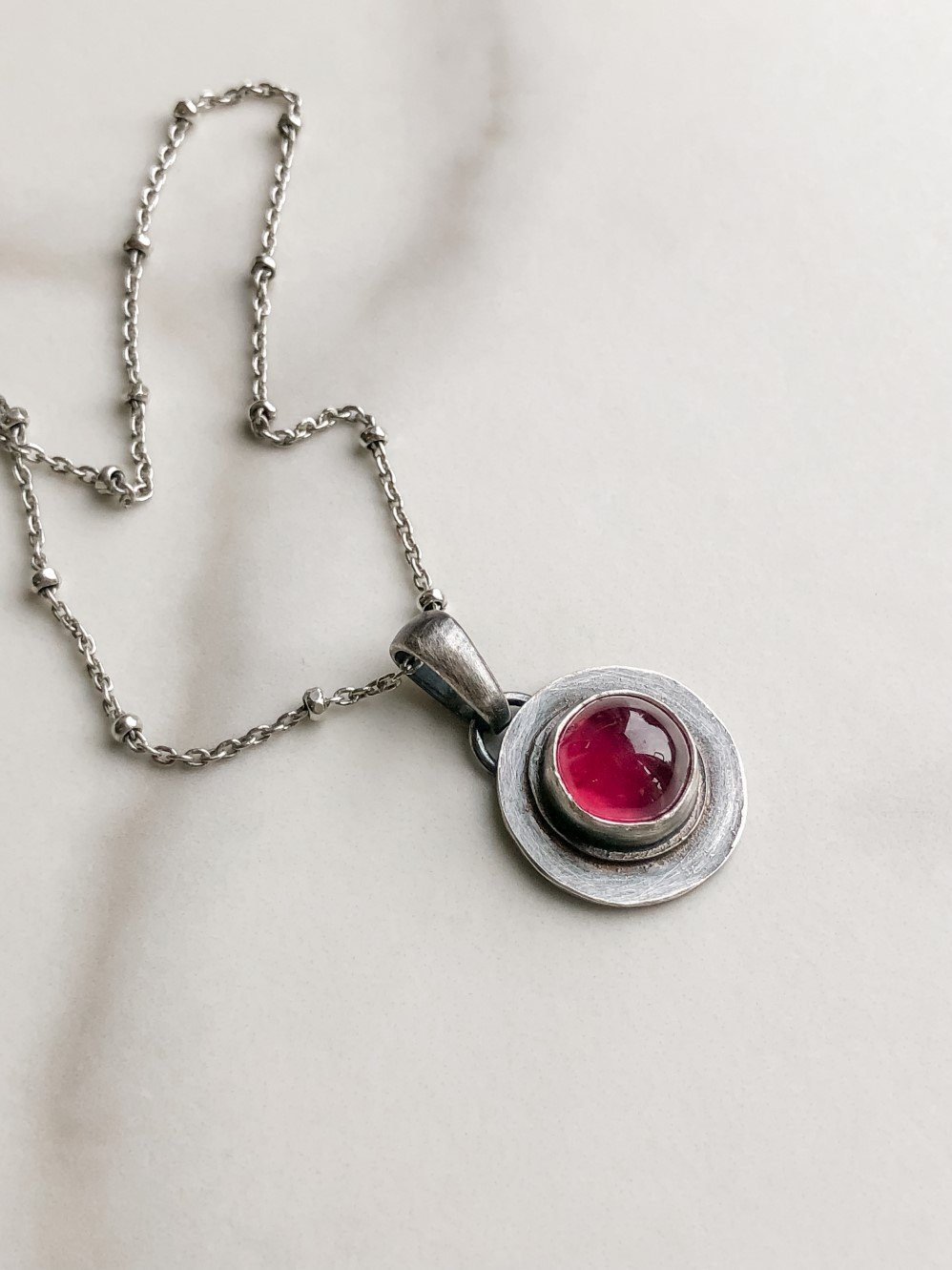 Round red ruby shape on flat  silver pendant on a ball chain
