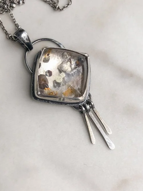 This Quartz stone has chunky, flowery Pyrite inside! There is a tiny bit of golden yellow-y orange coloring from iron oxides that is present in the stone.