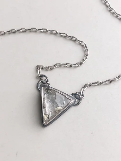 This piece features a clear Quartz stone with several flakes of light golden pyrite inside!  I have hand dipped this piece in oxidation, giving the metal a two-tone appearance.