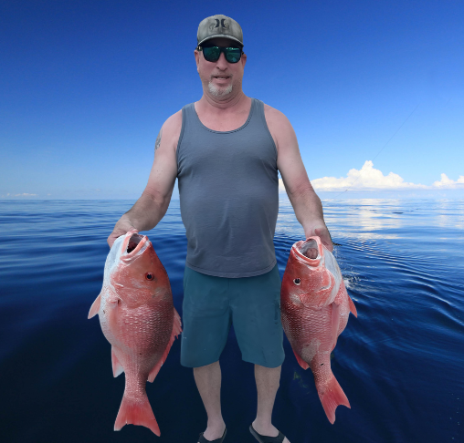 Man in a gray tank top, sunglasses, and baseball cap holding two large red fish on a calm ocean with a blue sky and some clouds.