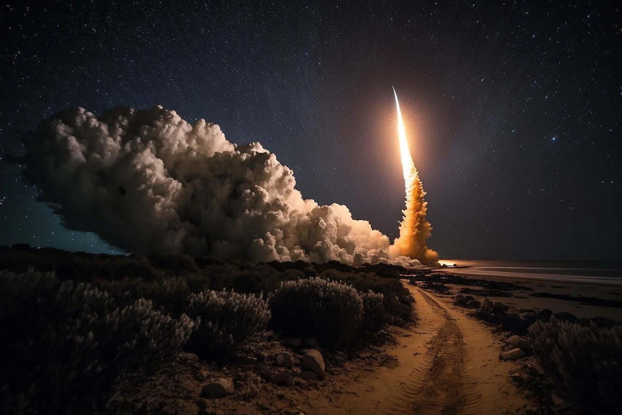 A rocket launching at night with smoke and fire, on a sandy path by the coast with starry sky in the background.