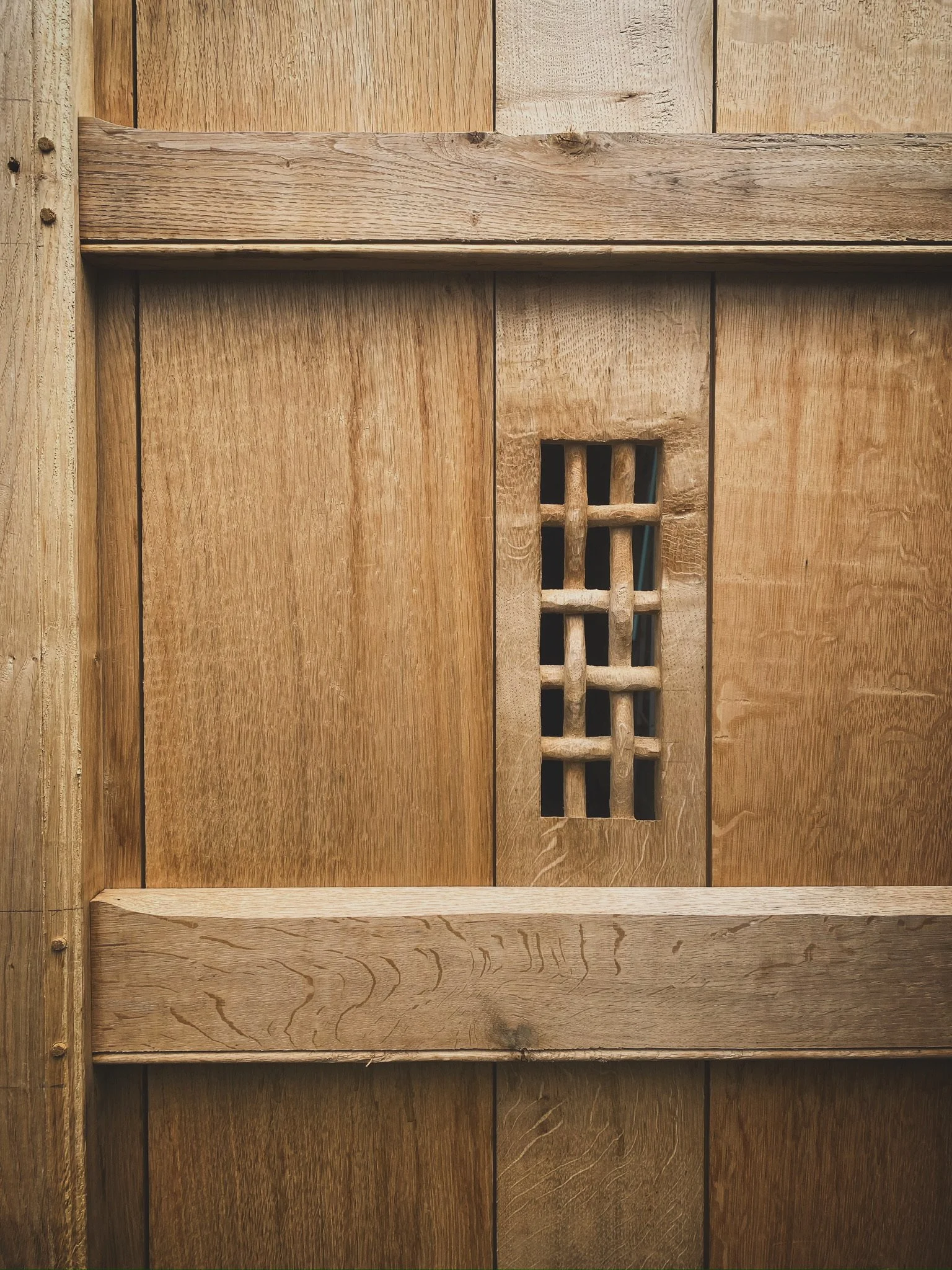 Knotted wood viewer in garden gate.
