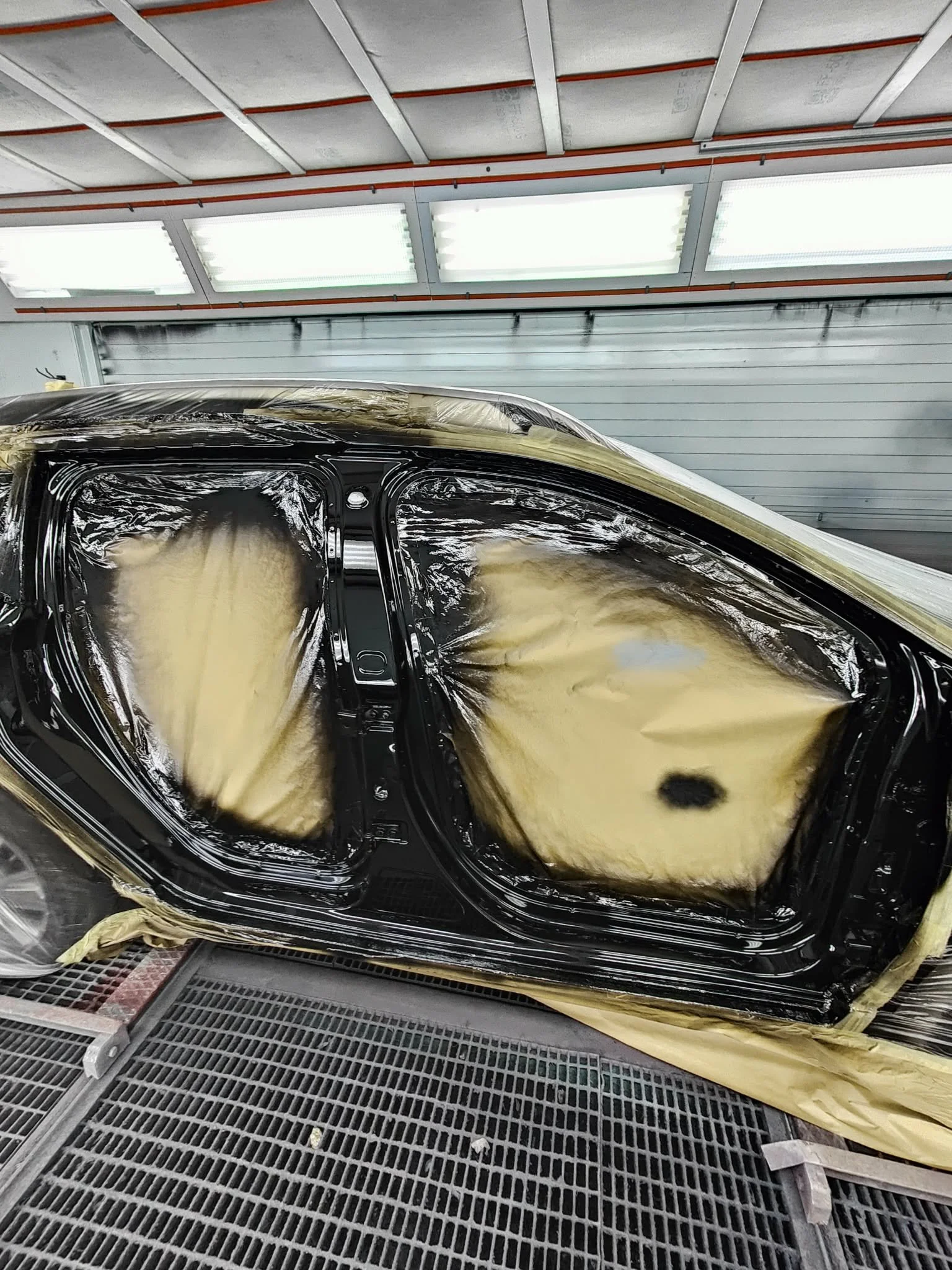 Masked car in spray booth