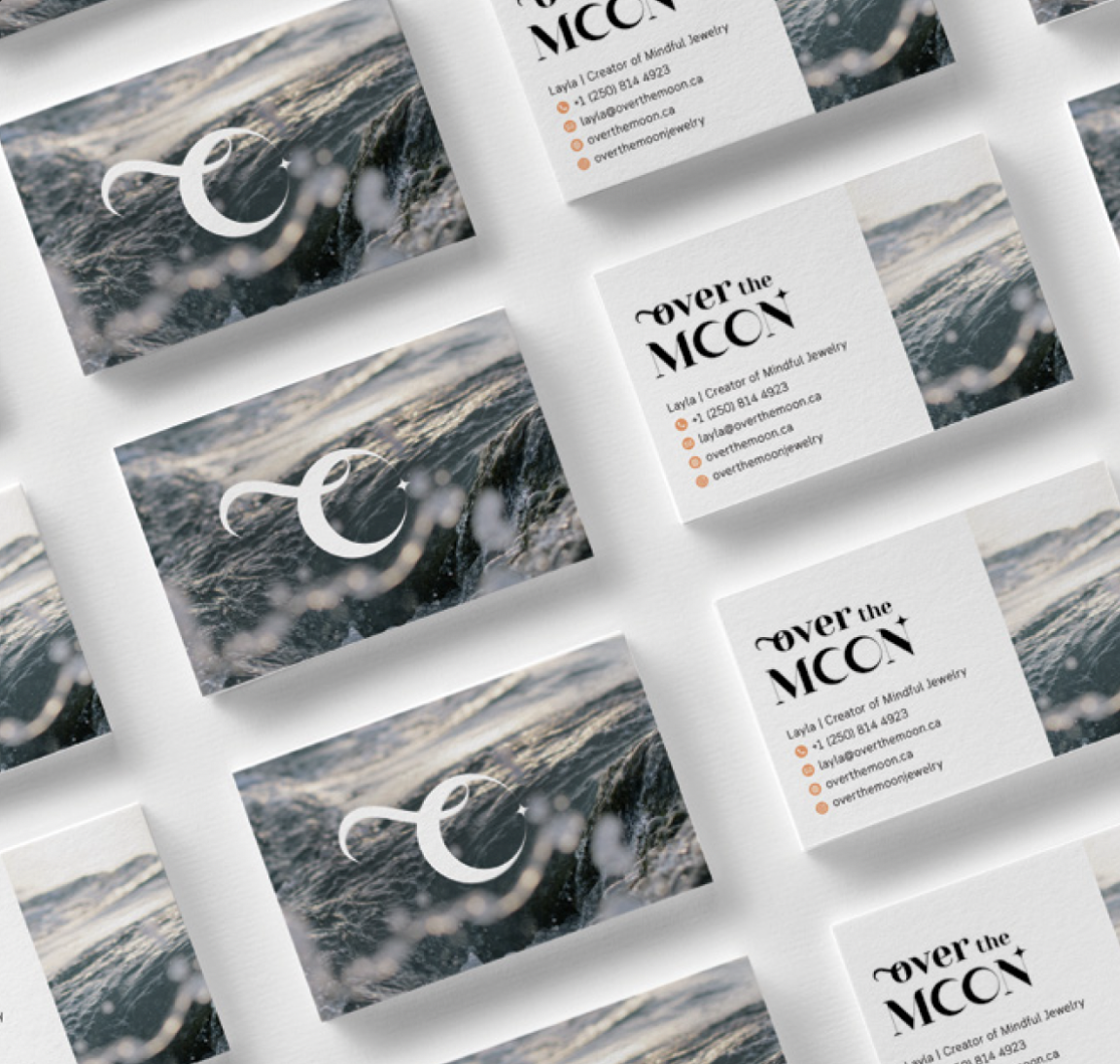 Business cards with a ocean wave background and a white ampersand symbol, alongside cards featuring the logo and contact information for 'over the MOON,' a jewelry brand.