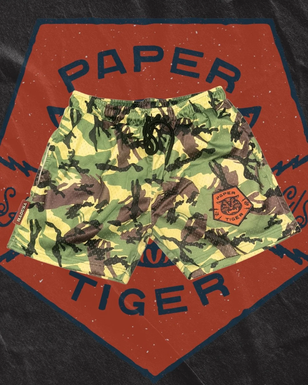 Custom camouflage shorts with embroidered tiger patch — Colorblox Merch Co. custom cut & sew merch sample