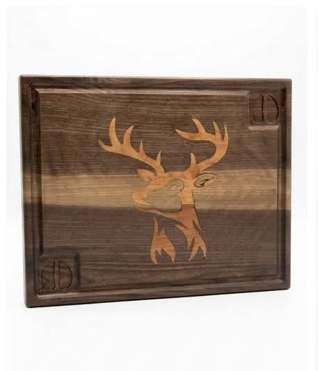 Walnut and cherry deer inlay cutting board with a juice groove and reservoir.  