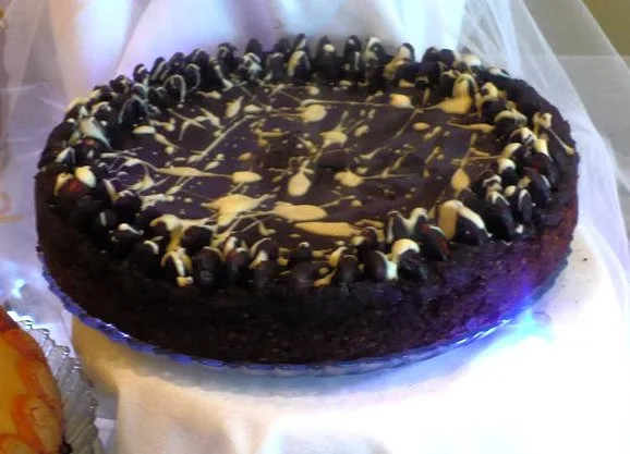 CHOCOLATE MACAROON TART Tastes like an Almond Joy bar! This 10-inch tart is filled with flaked coconut, chocolate and sweetened condensed milk. Three circles of whole almonds dipped in chocolate surround the edge of this chocolate-coated tart. We dri