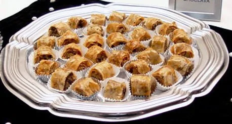 ROLLED BAKLAVA Rolled style baklava, flaky layers of phyllo with pecans and spices, dipped in honey syrup. (Min. order - 1 dozen)