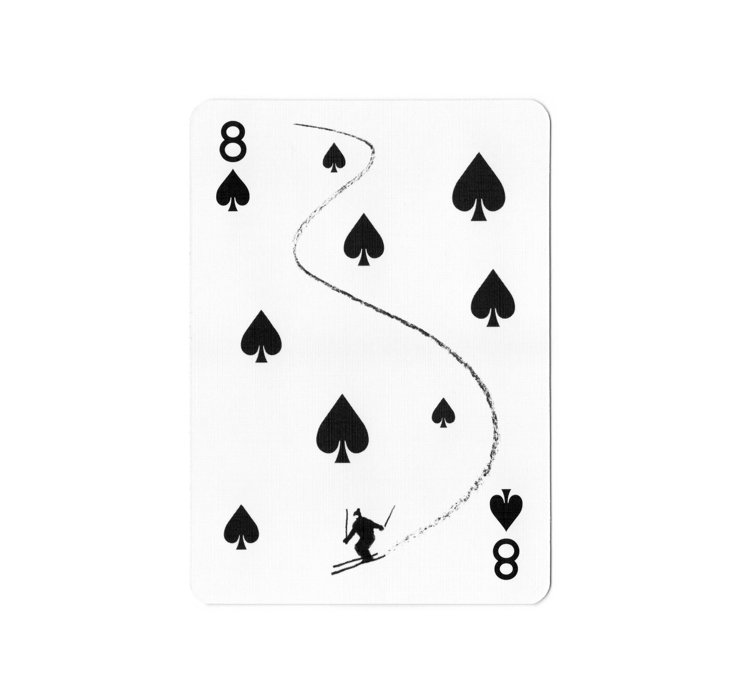 A black and white playing card of the eight of spades with a skier illustration and a track or trail design.