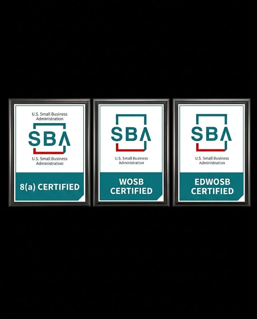 Three framed U.S. Small Business Administration certification plaques, labeled 8(a) Certified, WOSB Certified, and EDWOSB Certified, displayed against a black background.
