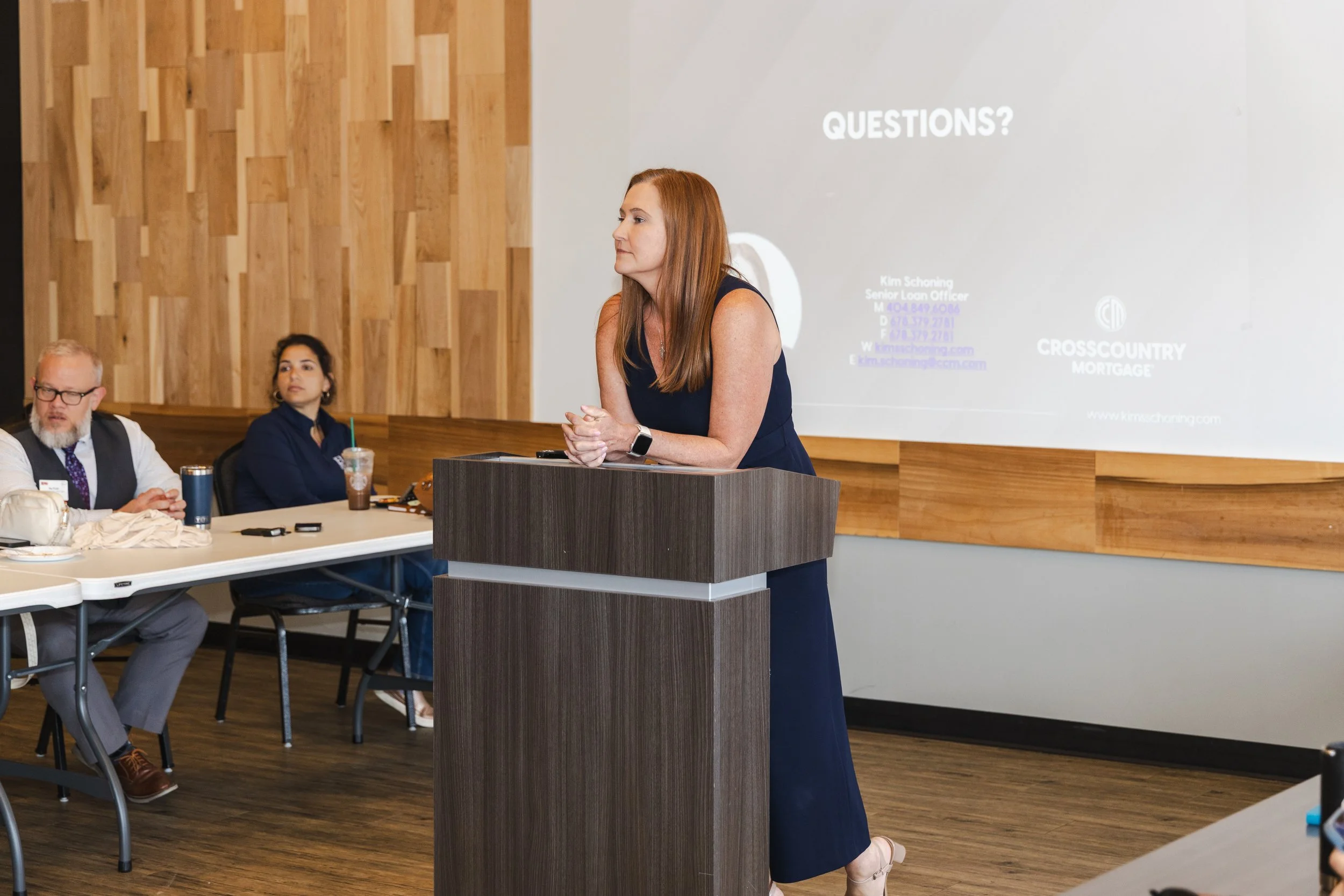 Speaker presenting at a podium during a business conference session, corporate event photography by Foundation Media Group