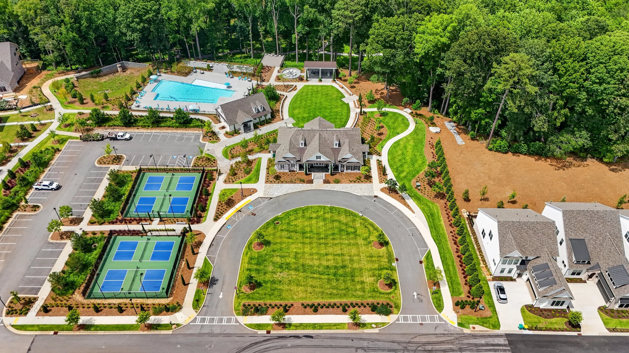 Aerial drone photo of a luxury estate with tennis courts, pool, and manicured grounds, real estate photography by Foundation Media Group in Peachtree Corners, Georgia