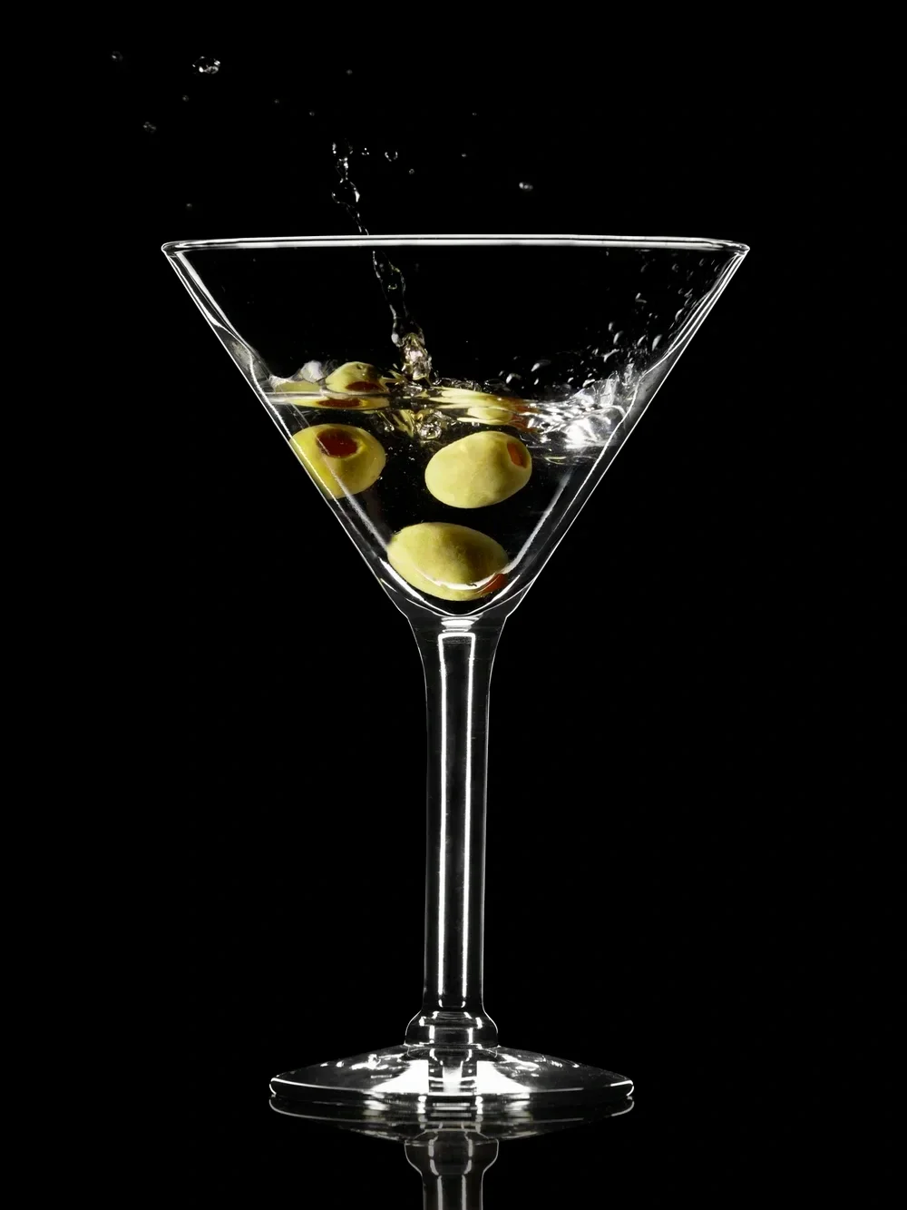 cocktail with olives on a black background