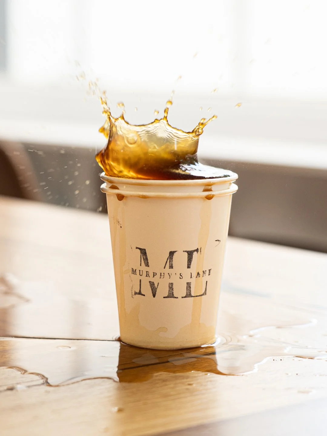Coffee spilling out of coffee cup
