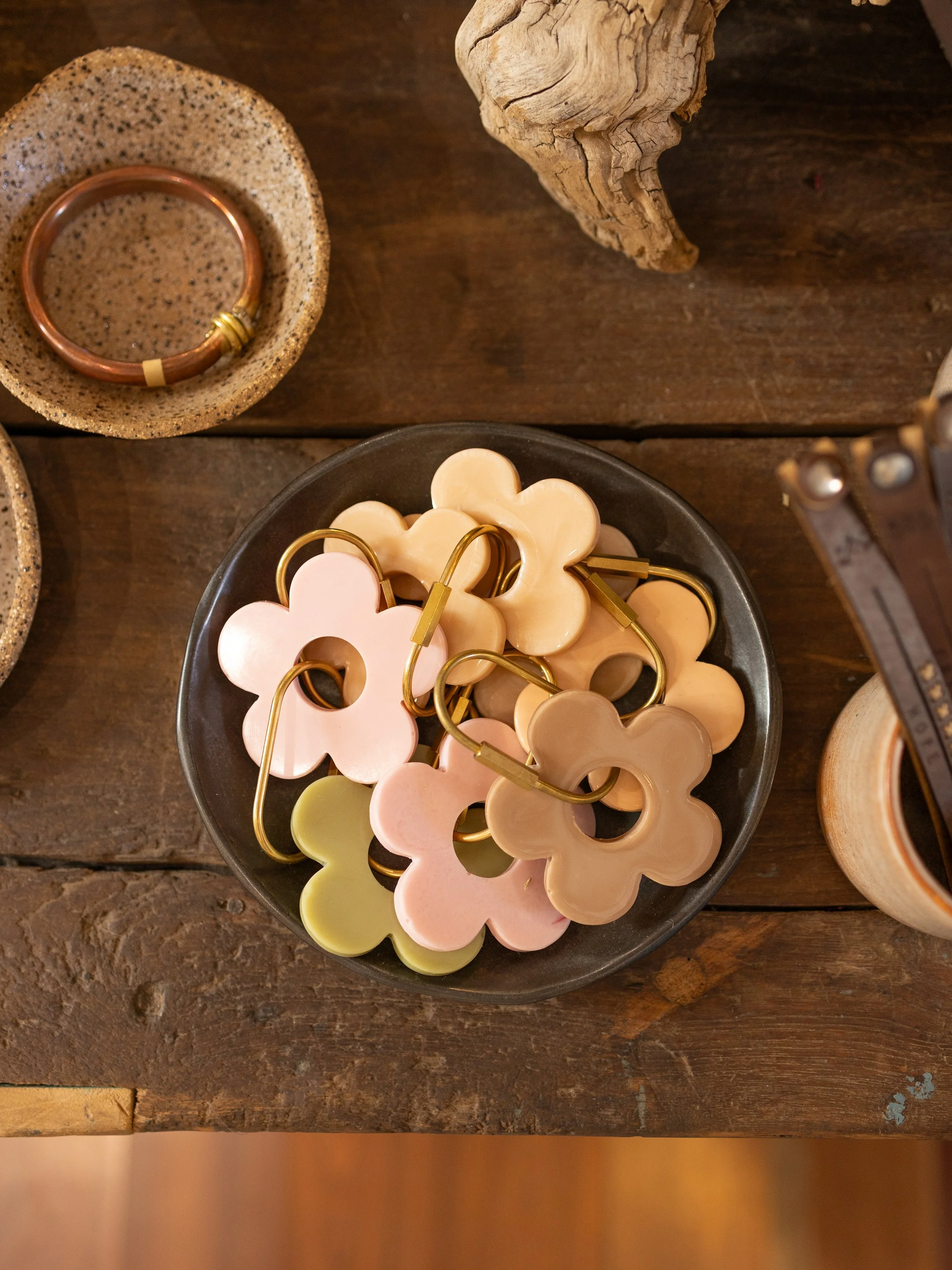 Flower key rings sitting on plate on table