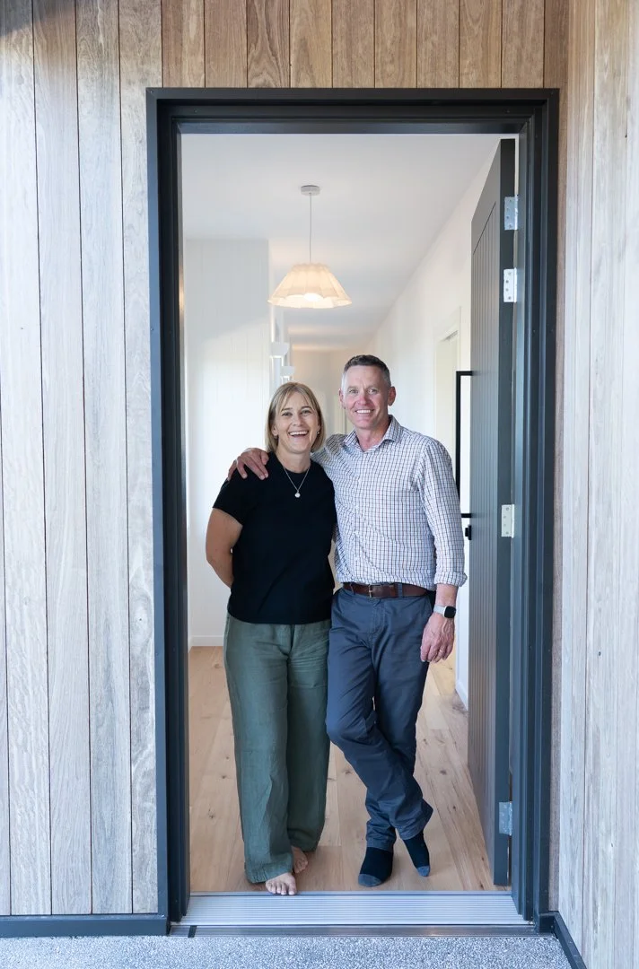 Couple standing in doorway of their new home