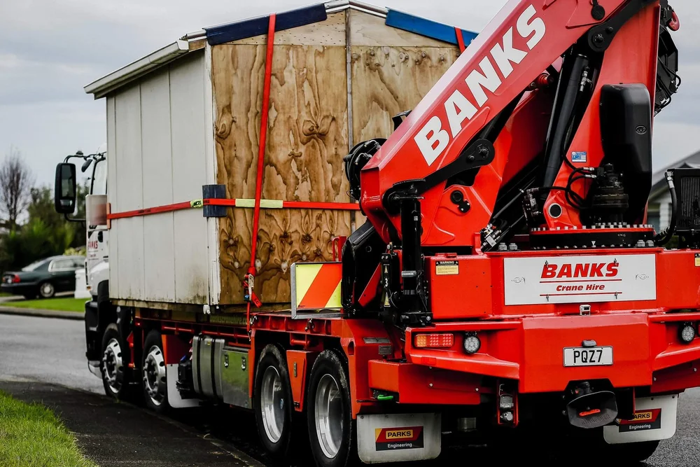 Rear-mounted Banks HIAB crane behind a cabin on the truck deck