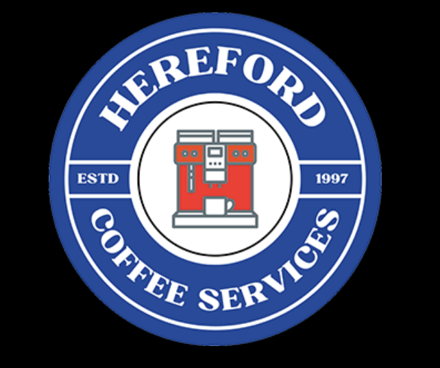 A circular logo for Hereford Coffee Services featuring a red coffee machine illustration in the center, surrounded by blue and white text and borders, established in 1997.