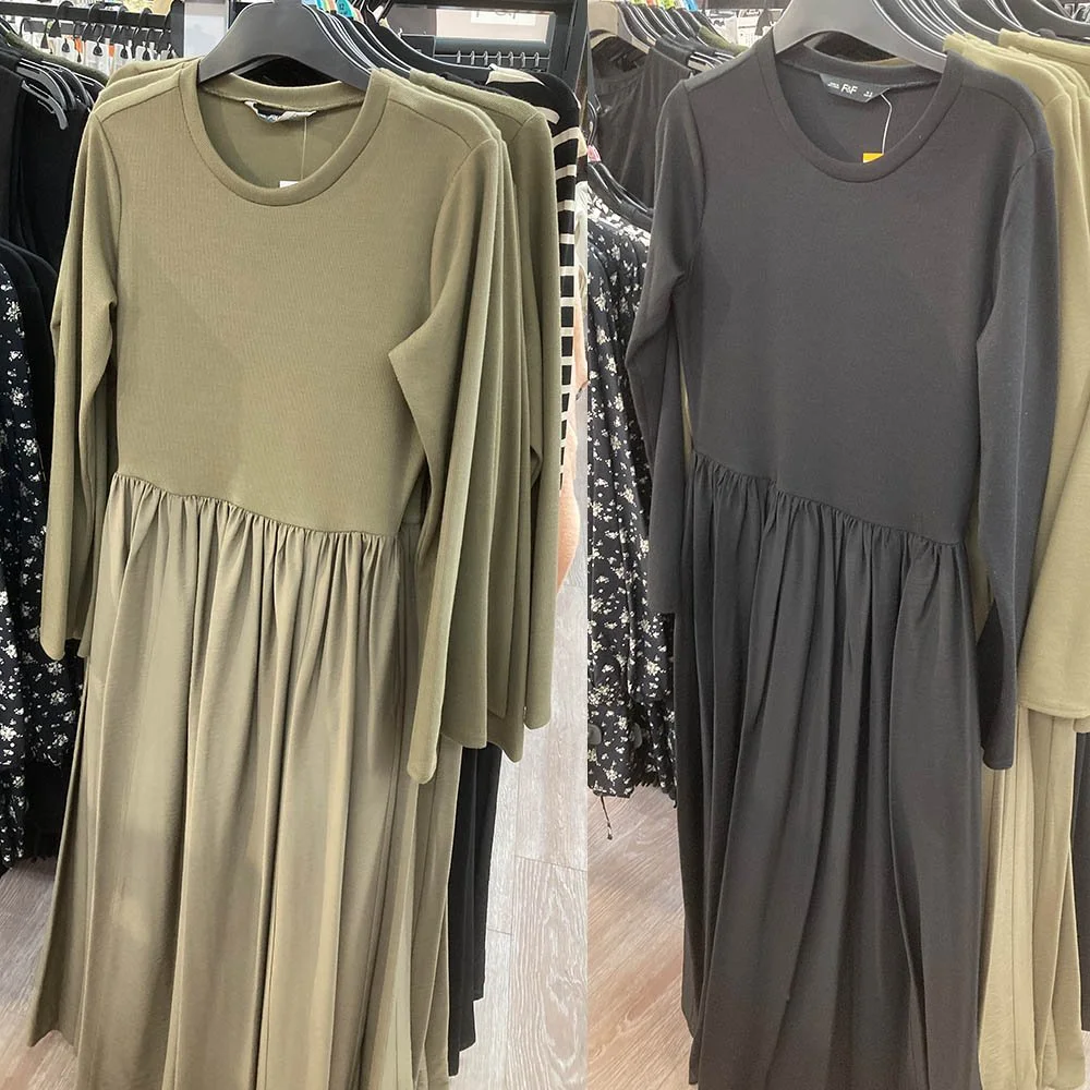 Two long-sleeved dresses, one in a tan khaki and the other in black.