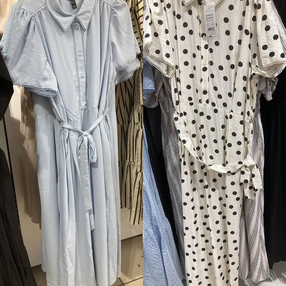 On the left a pale blue dress, on the right a white dress with a black polka dot pattern.