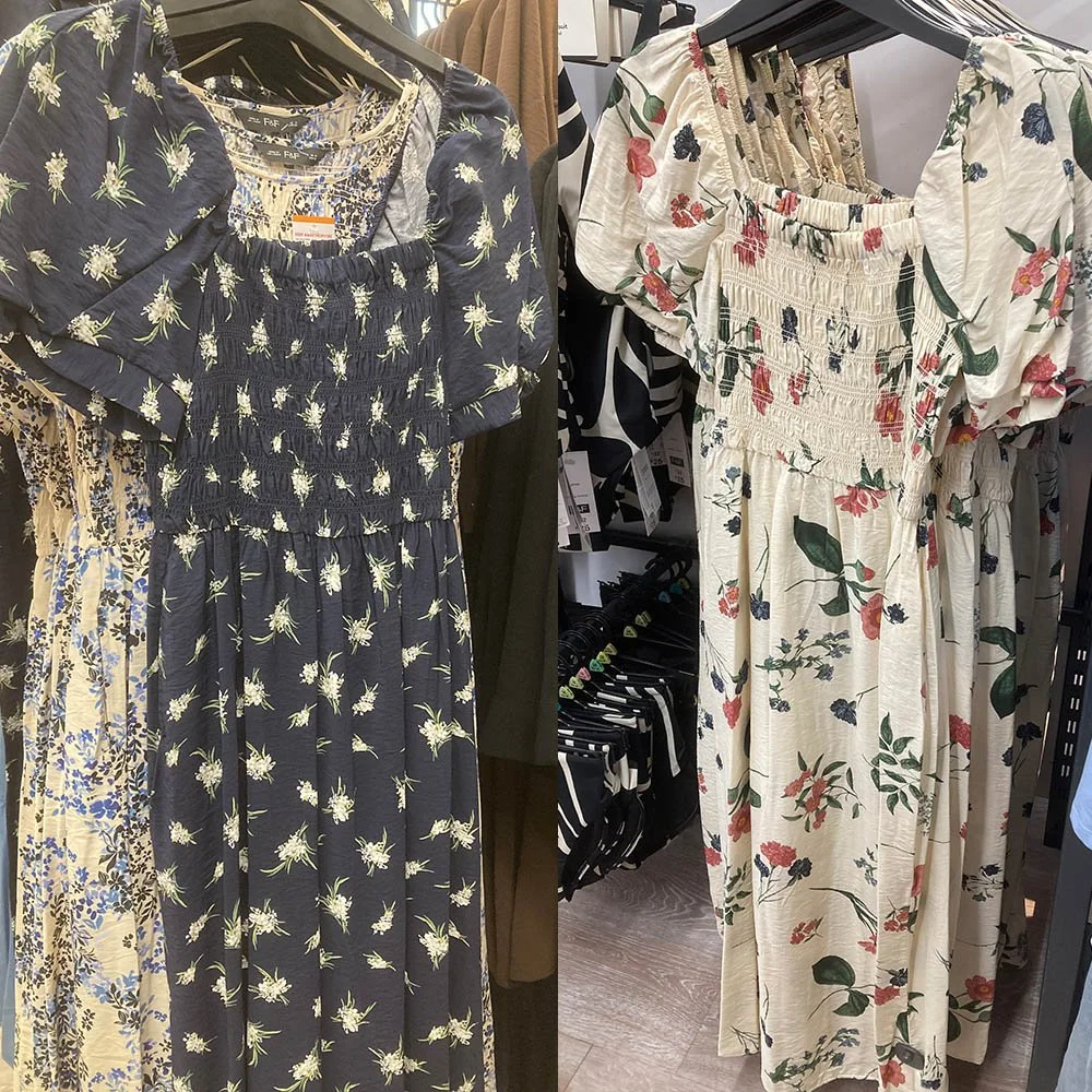 Two tea dresses, one in dark blue and one in cream, with floral patterns.