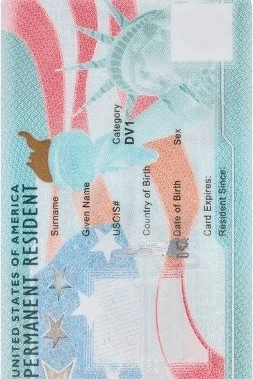 A U.S. Permanent Resident Card with the Statue of Liberty in the background, showing personal details like name, date of birth, country of birth, and card expiration date.