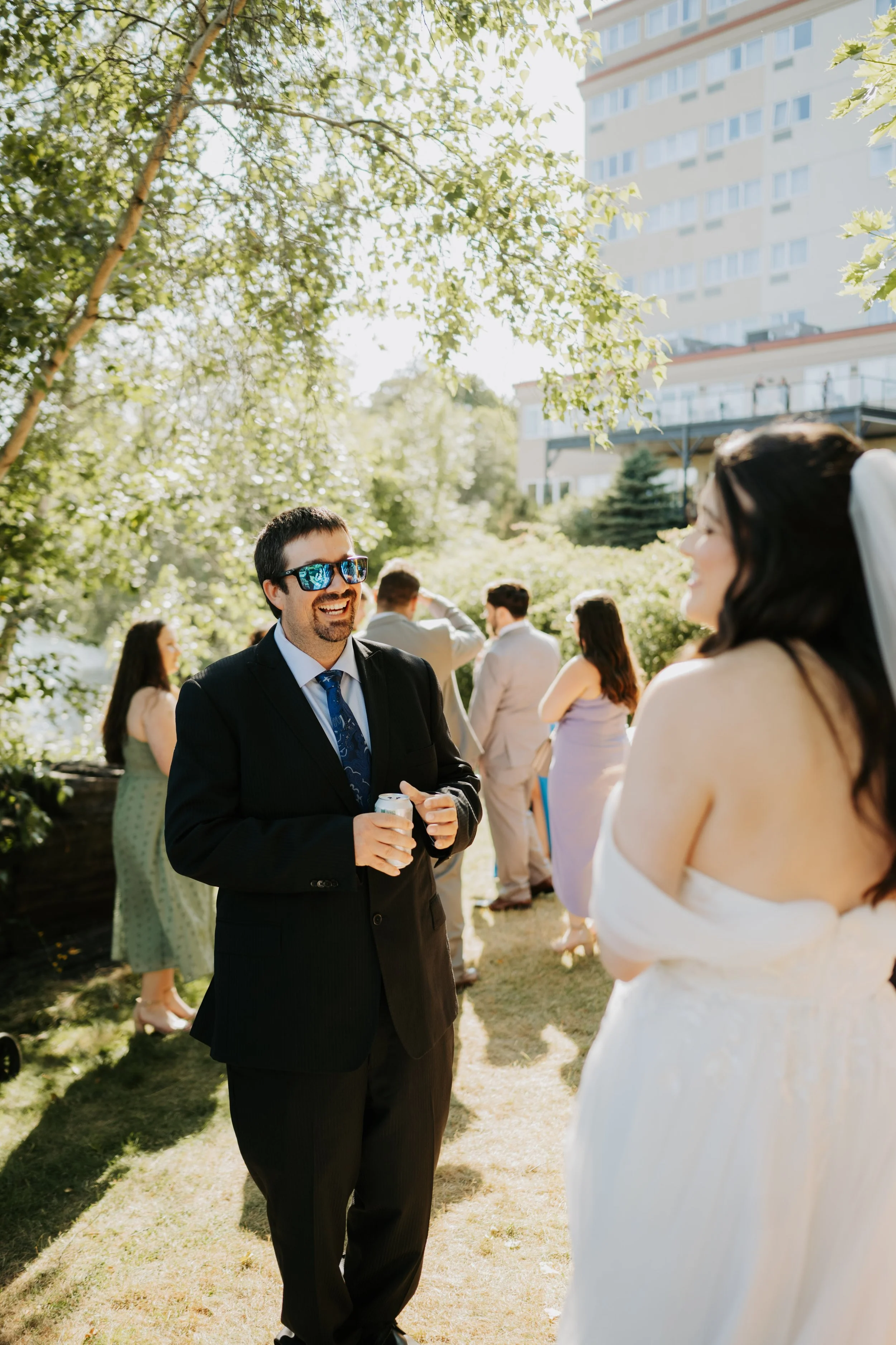 A man and bride talking lakeside at her wedding being held at Best Western Plus Chocolate Lake.