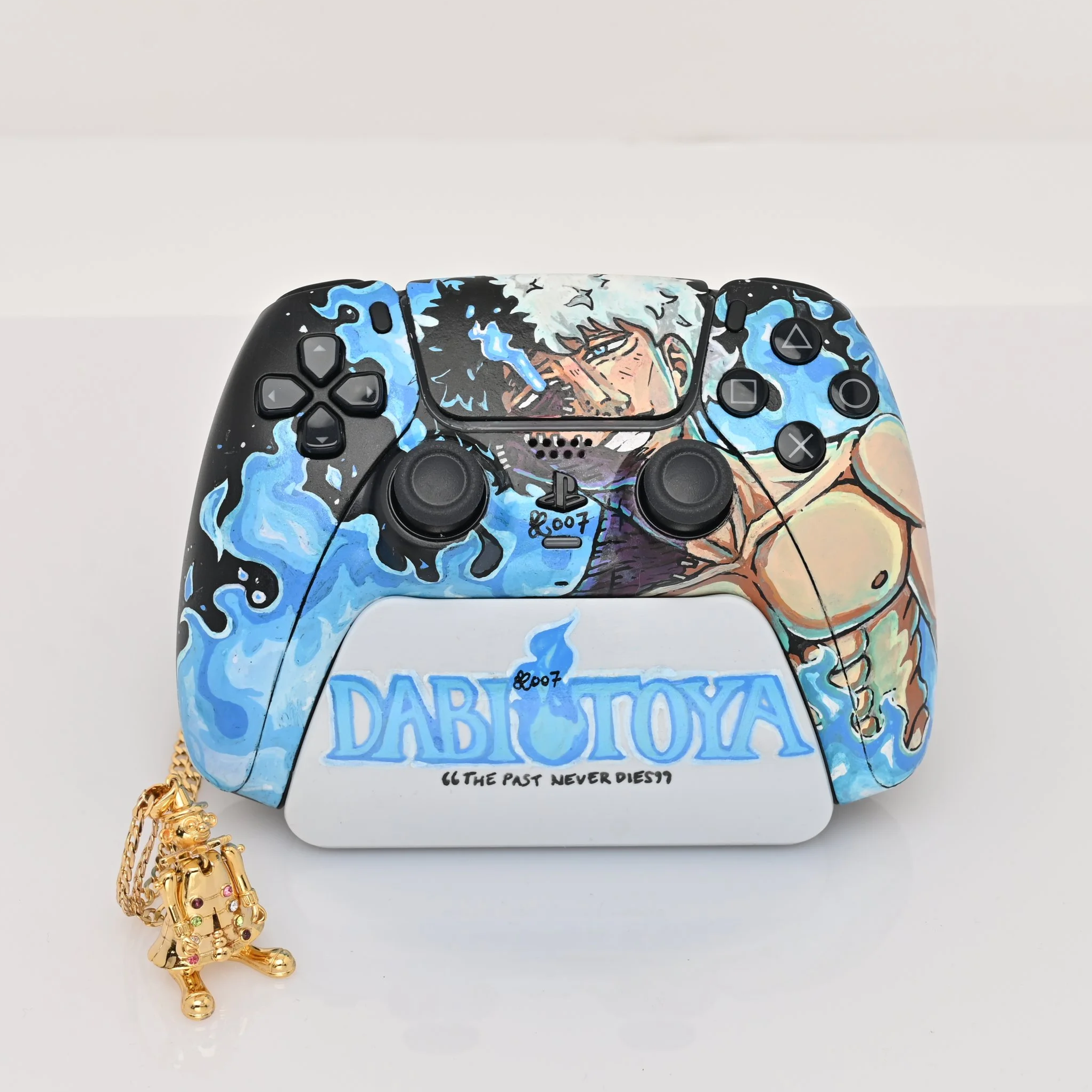 Custom-painted PlayStation 5 controller with anime-inspired artwork, featuring dabi from my hero academia and blue flame design, with a gold clown charm necklace.