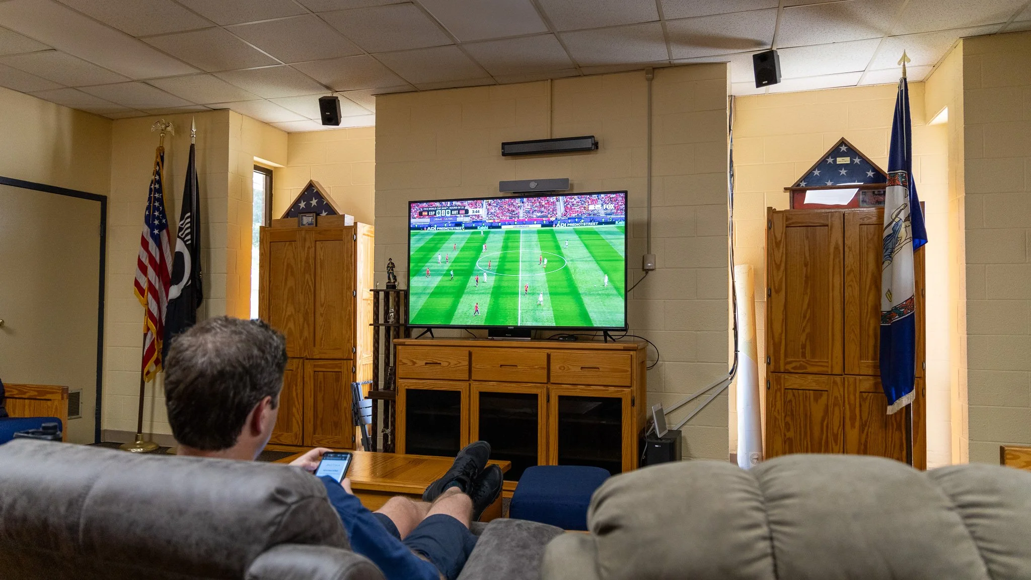 Virginia Beach, Virginia, 2 July 2026 -- Reclined: A VBFD firefighter watches a world cup match while on duty at Station 8. Photo: Jesse Ankney