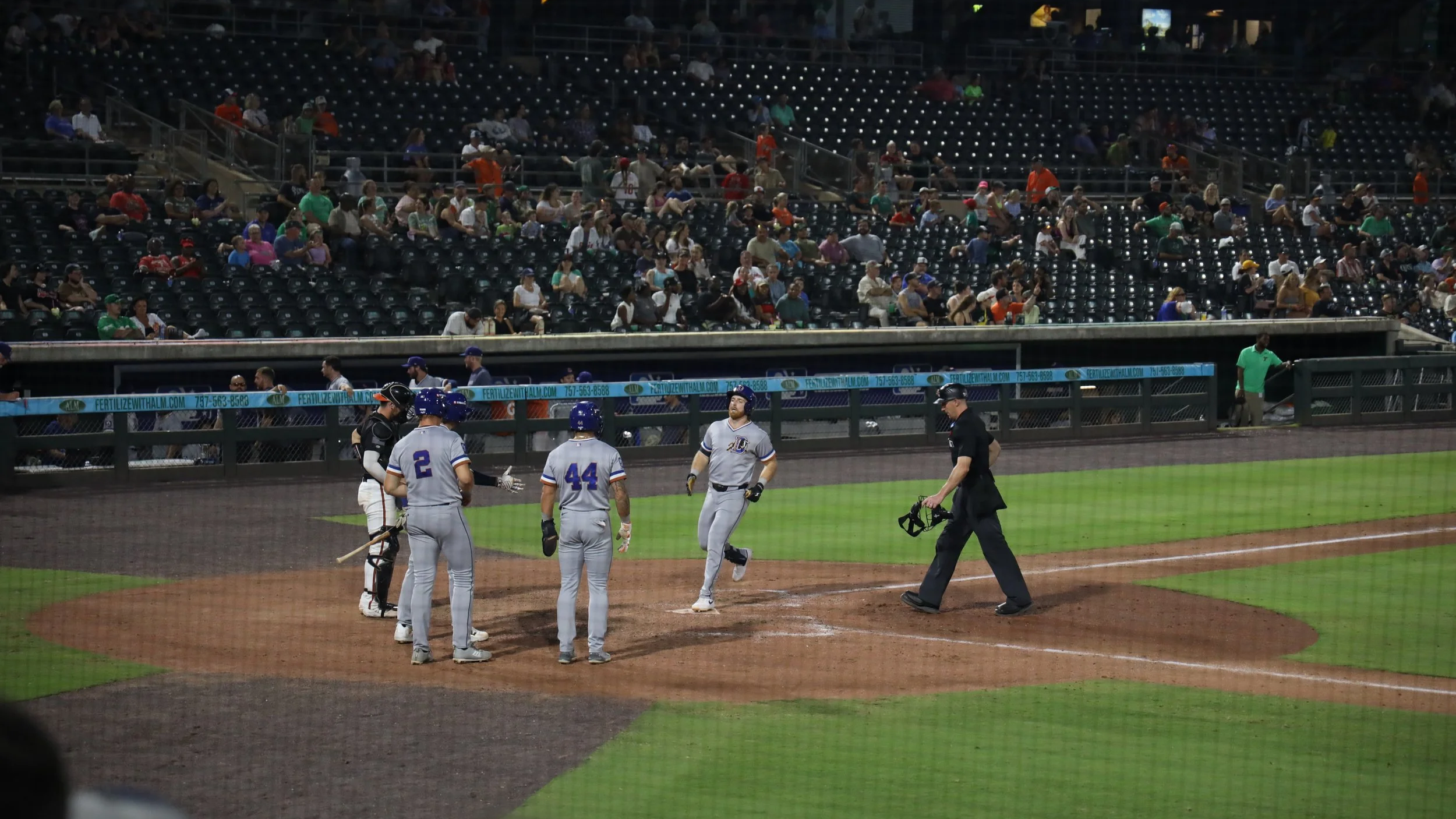 Norfolk, Virginia, 26 June 2026 - Payback: Durham's first three runs crowd home plate. Photo: Jesse Ankney