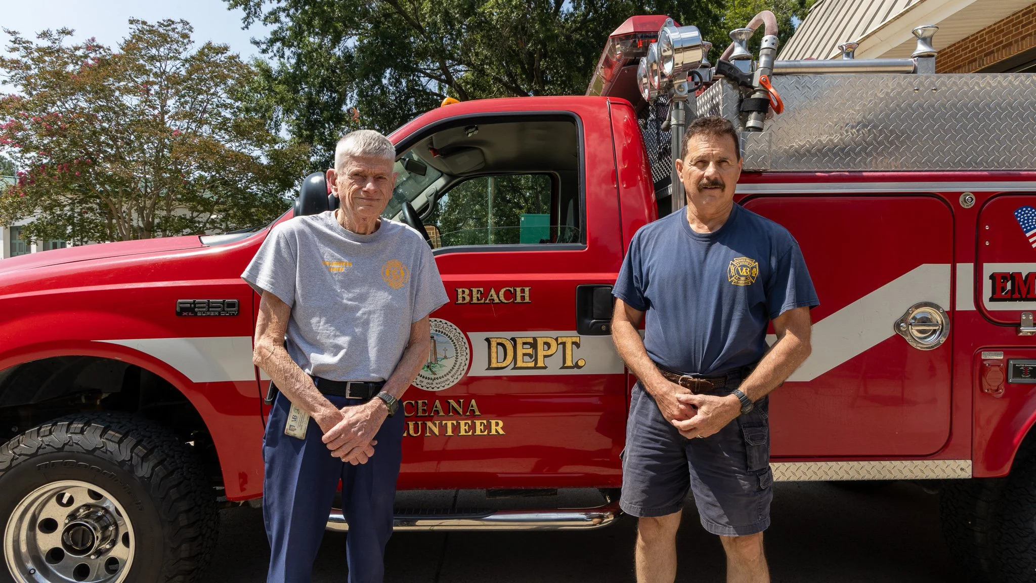 Virginia Beach, Virginia, 2 July 2026 -- Posted: Wayne Richardson (left) and Steven Kennedy (right) in front of OVFD Brush 8. Photo: Jesse Ankney.