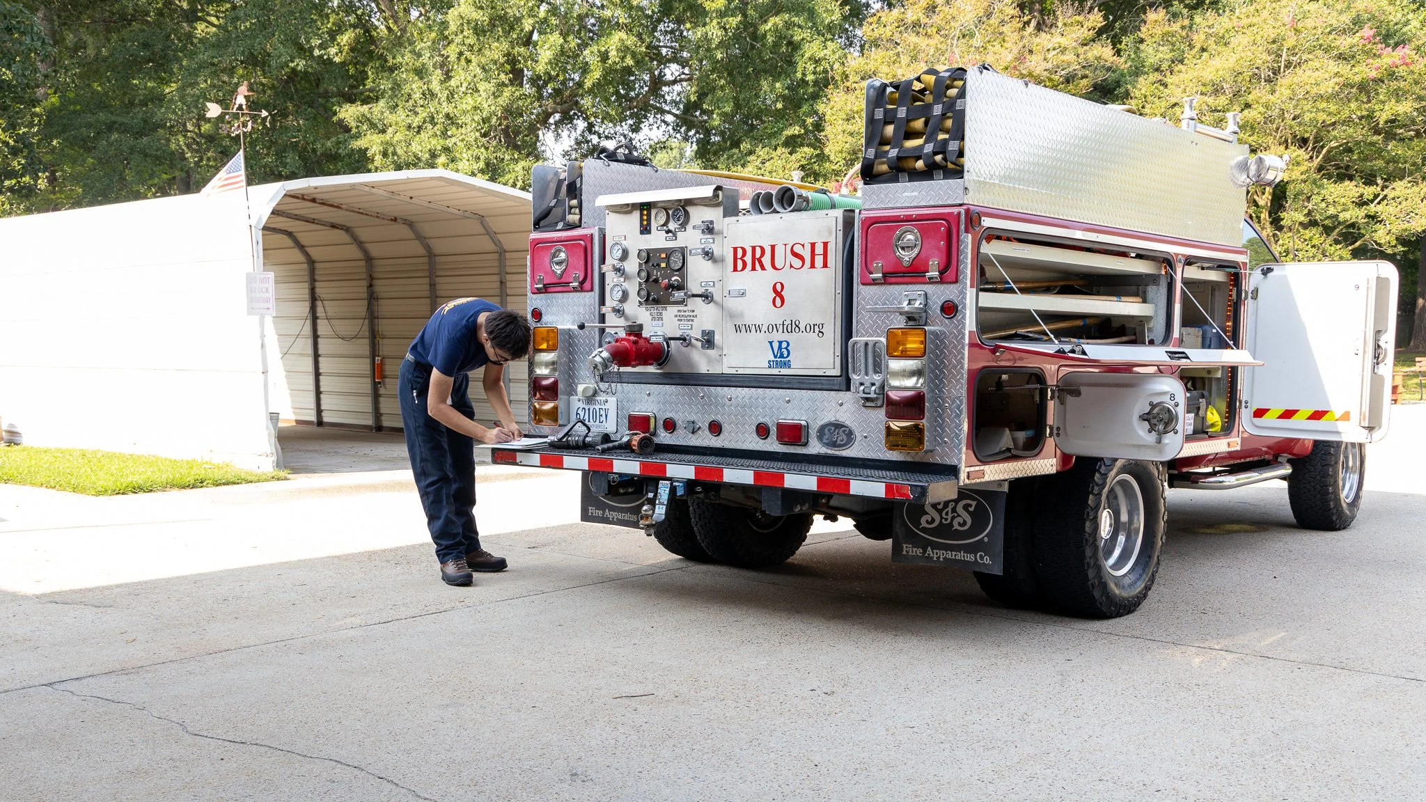 Virginia Beach, Virginia, 4 July 2026 -- Checklist: An OVFD volunteer runs through preparations before the department leads the Alanton neighborhood Independence Day parade. Photo: Jesse Ankney.