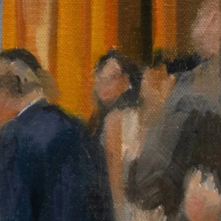 Three people in formal attire at an indoor event, with a background of orange and yellow curtains.