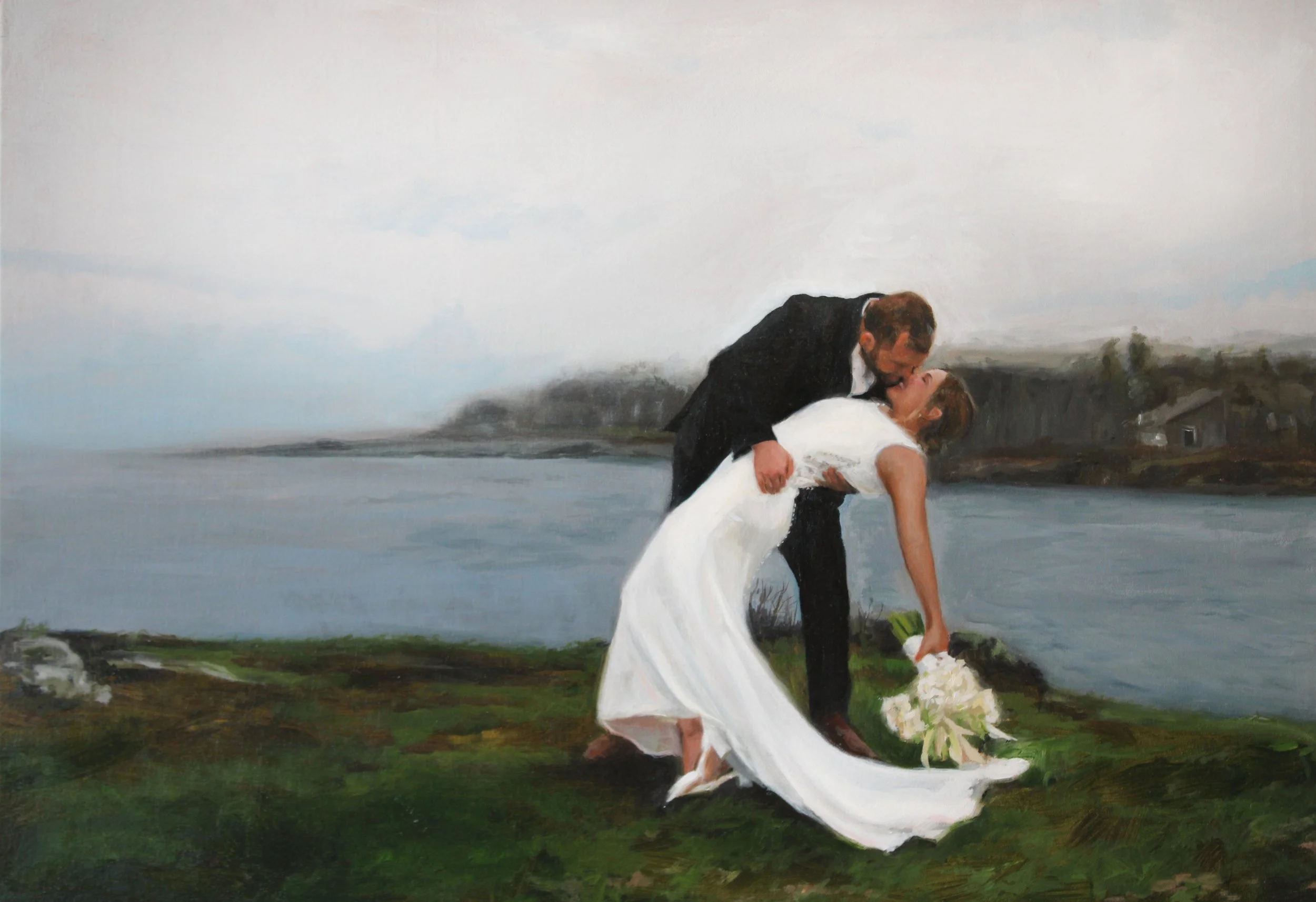 couple in front of maine's ocean in a dip kiss