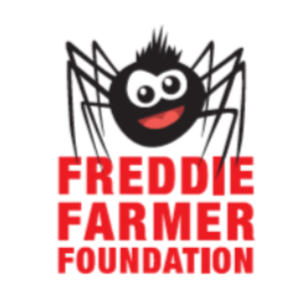 Logo of the Freddie Farmer Foundation featuring a cartoon spider with a round black body, big eyes, a smiling face, and eight legs, with the foundation's name in bold red letters beneath.