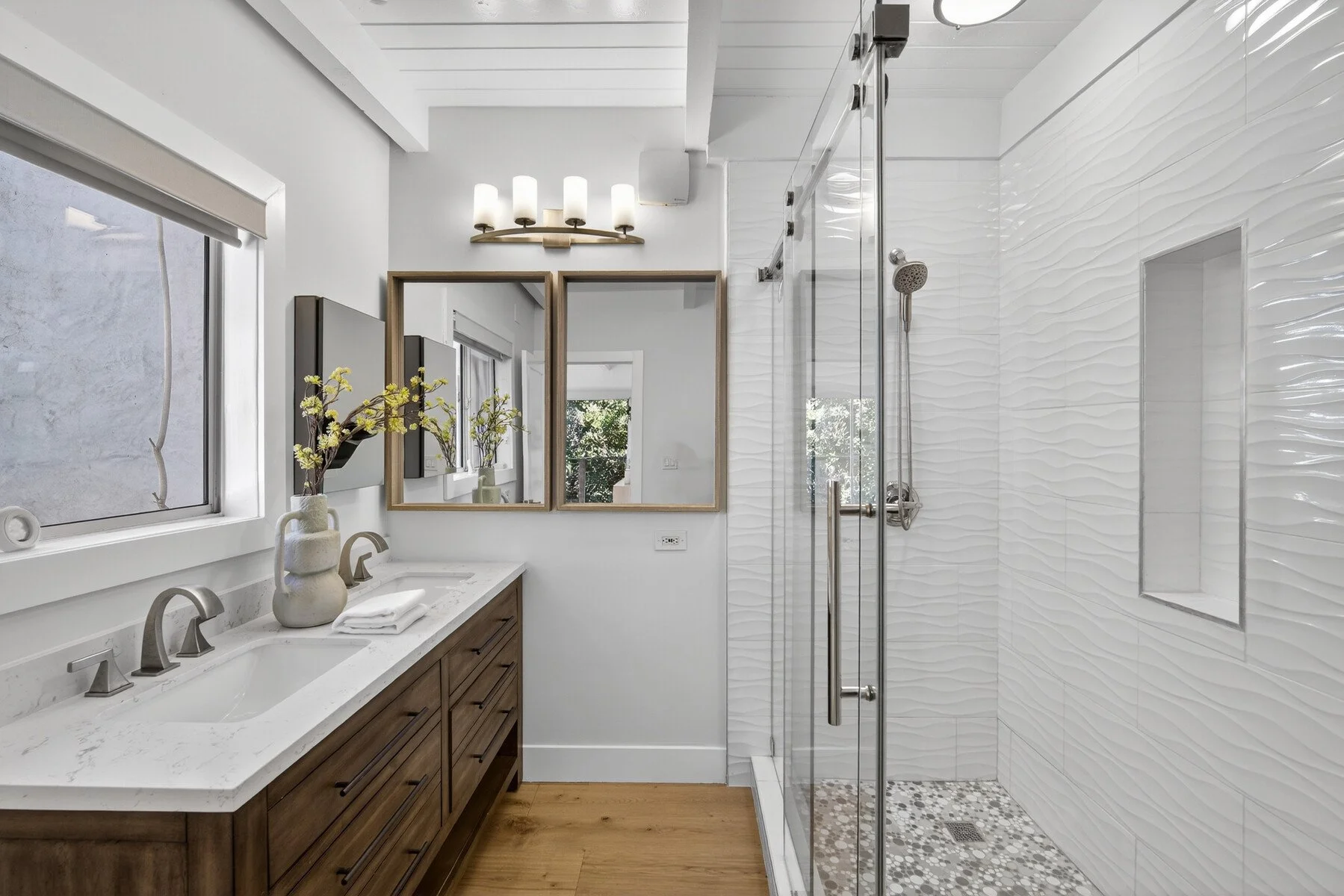 Primary bathroom with dual sinks and oversized walk-in shower.