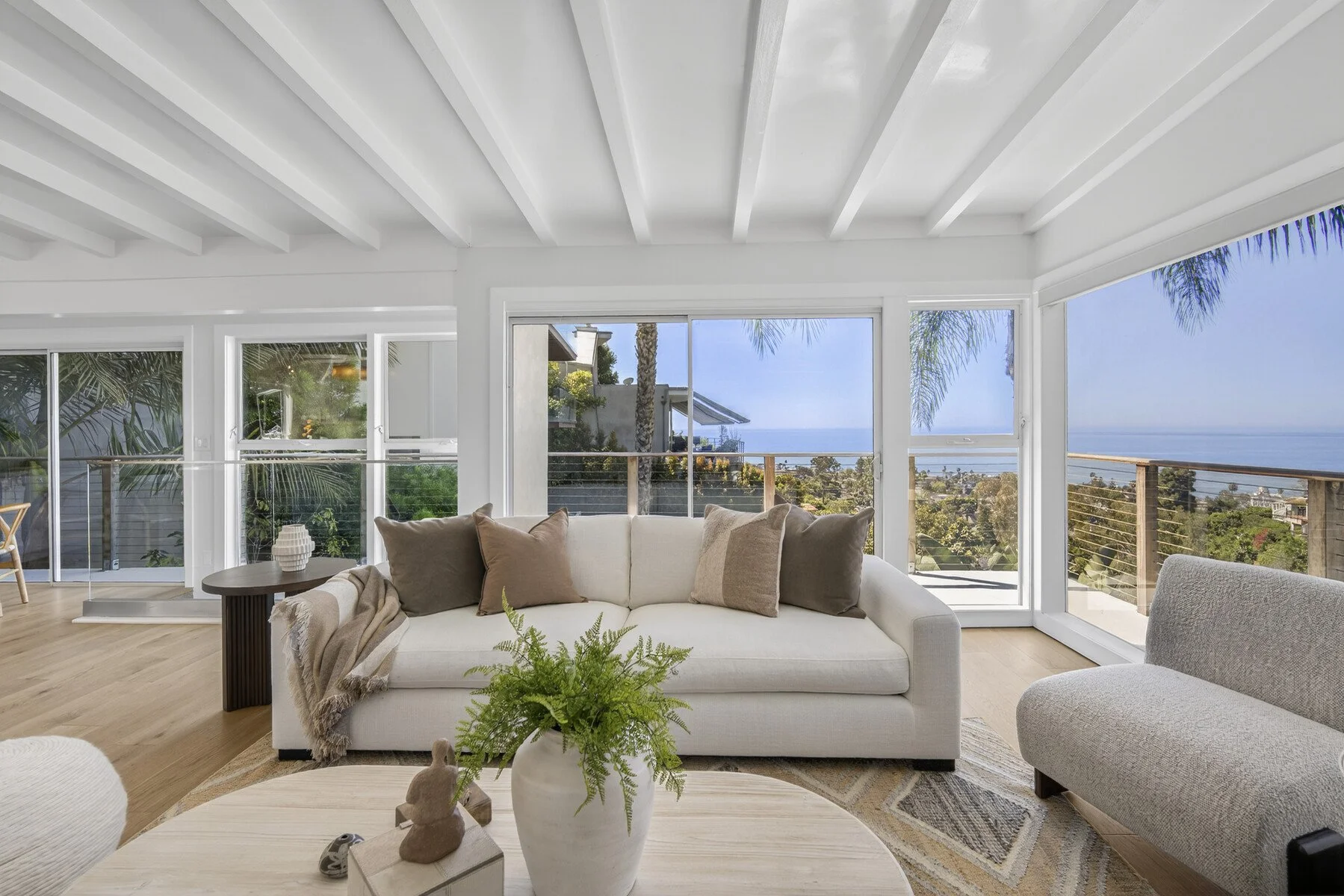Ocean View Living Room with floor to ceiling windows opening to a private wrap around terrace