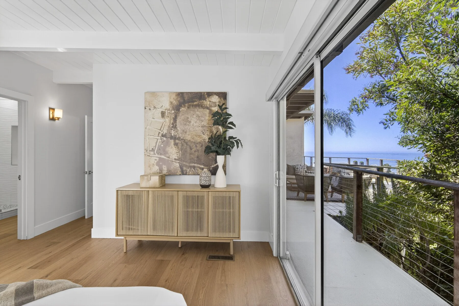 Primary suite with ocean views and terrace access.
