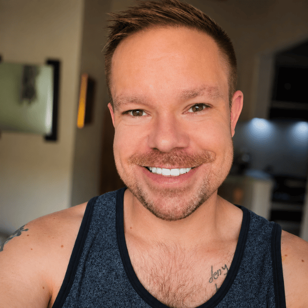 Author Kevin Snell smiling in a casual indoor profile photo for the Kevin Snell