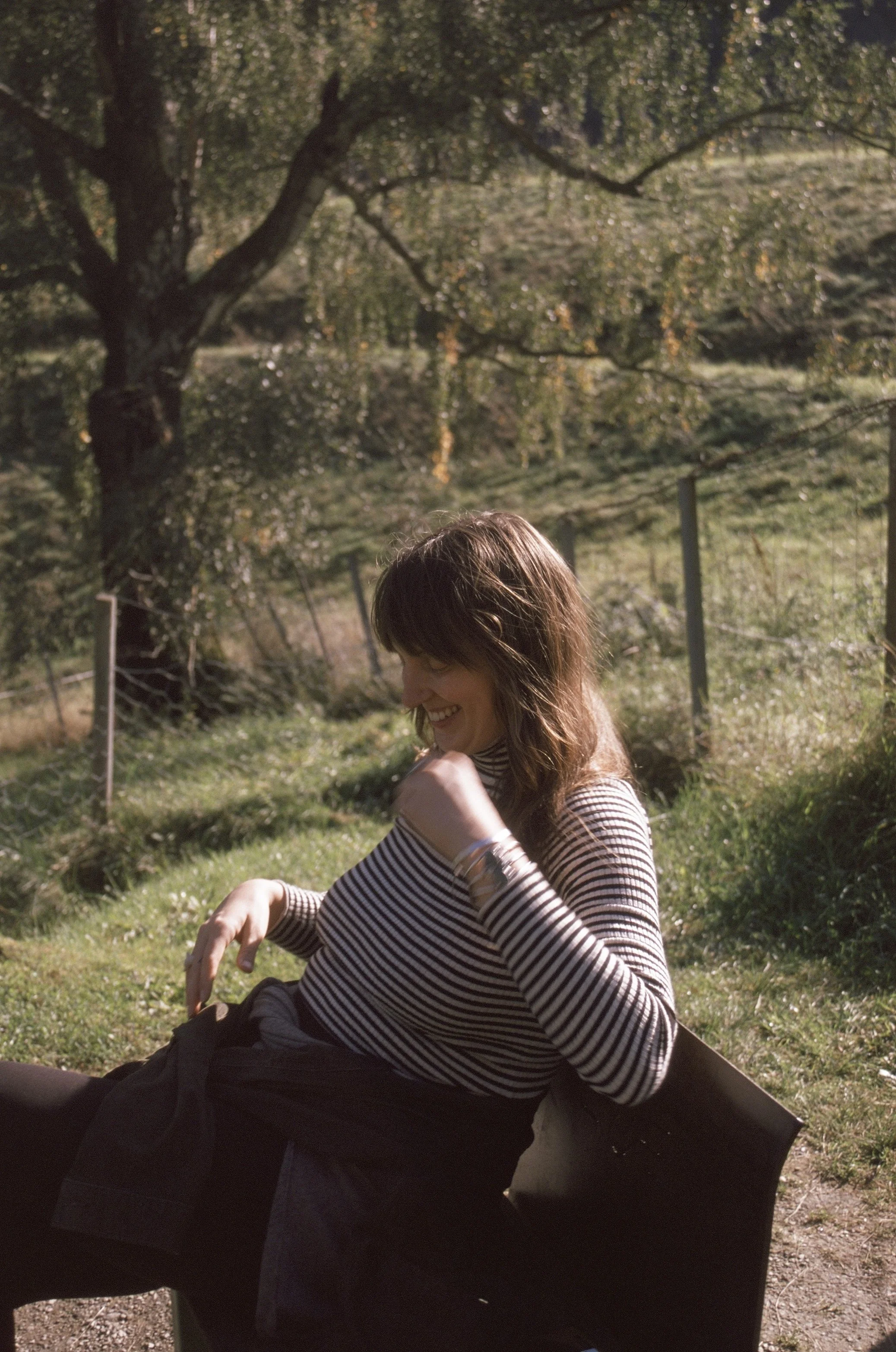 Rachael Ellis sitting on bench in Norway laughing