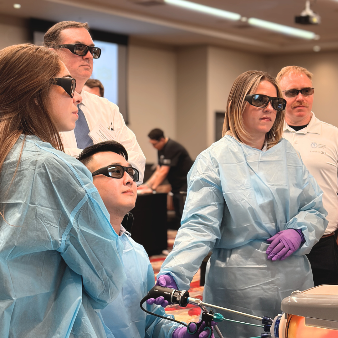 Group of medical professionals wearing protective gear and 3D glasses in a training or presentation setting.